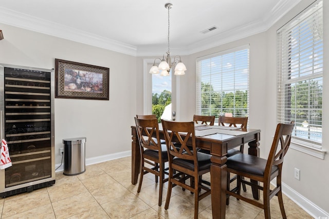dining room with beverage cooler, a chandelier, ornamental molding, plenty of natural light, and light tile patterned floors