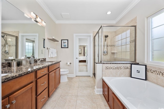 bathroom with a shower stall, ornamental molding, vanity, a garden tub, and toilet