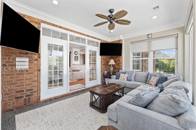 living room with ceiling fan, ornamental molding, brick wall, and recessed lighting