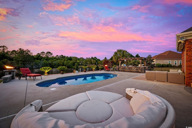pool at dusk featuring an outdoor living space and a patio area