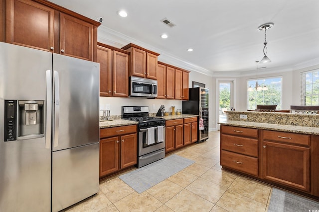 kitchen featuring stainless steel appliances, ornamental molding, brown cabinetry, hanging light fixtures, and light stone counters