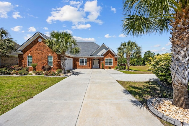 view of front of house featuring driveway, a garage, brick siding, and a front yard