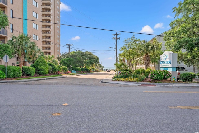 7403 N Ocean Blvd Unit C, Myrtle Beach, SC 29572 - view of asphalt road with curbs, sidewalks, street lighting, and traffic signs