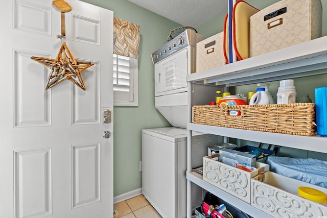 7403 N Ocean Blvd Unit C, Myrtle Beach, SC 29572 - laundry room featuring light tile patterned floors, stacked washer / drying machine, and baseboards