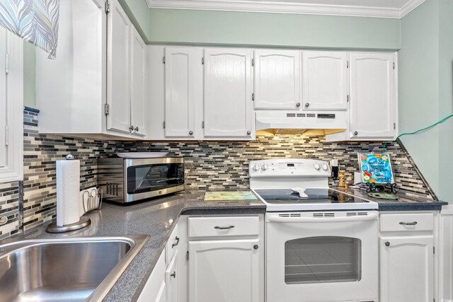 7403 N Ocean Blvd Unit C, Myrtle Beach, SC 29572 - kitchen with electric range, under cabinet range hood, white cabinetry, dark countertops, and ornamental molding