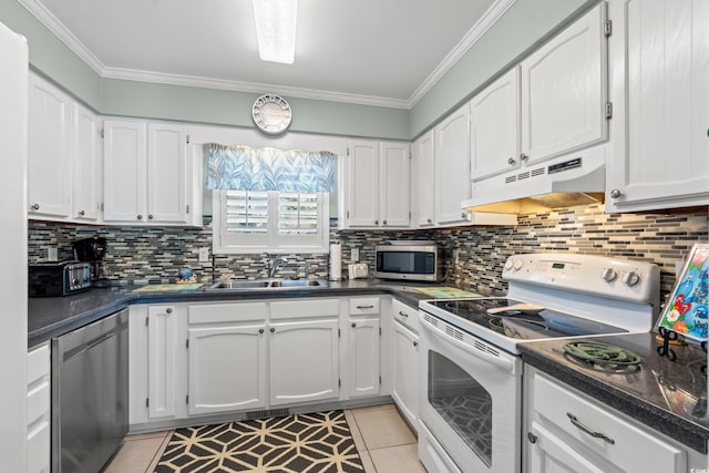 7403 N Ocean Blvd Unit C, Myrtle Beach, SC 29572 - kitchen featuring stainless steel appliances, under cabinet range hood, a sink, dark countertops, and white cabinetry