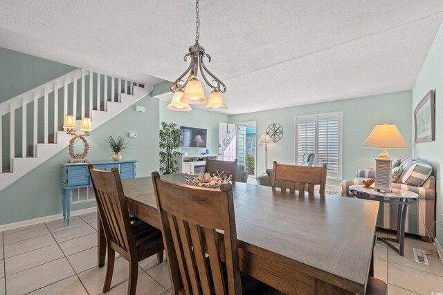7403 N Ocean Blvd Unit C, Myrtle Beach, SC 29572 - dining room featuring stairs, light tile patterned floors, a textured ceiling, and baseboards
