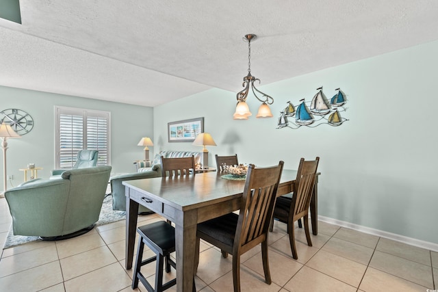7403 N Ocean Blvd Unit C, Myrtle Beach, SC 29572 - dining area with light tile patterned flooring, a textured ceiling, and baseboards