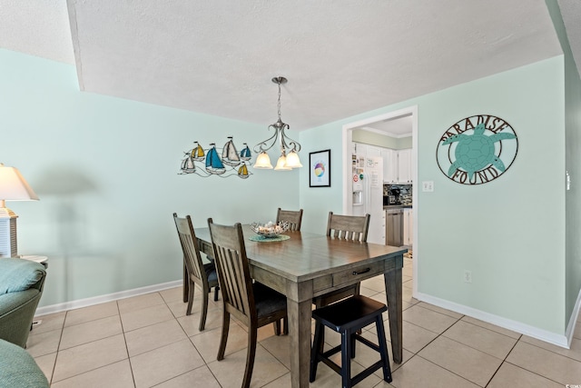 7403 N Ocean Blvd Unit C, Myrtle Beach, SC 29572 - dining room with light tile patterned flooring, a chandelier, baseboards, and a textured ceiling