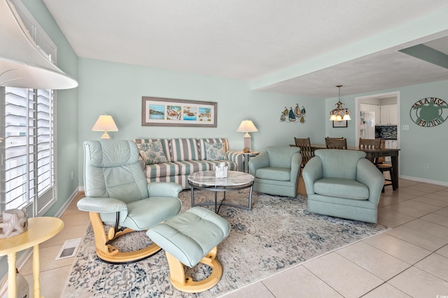 7403 N Ocean Blvd Unit C, Myrtle Beach, SC 29572 - tiled living room featuring baseboards and a chandelier