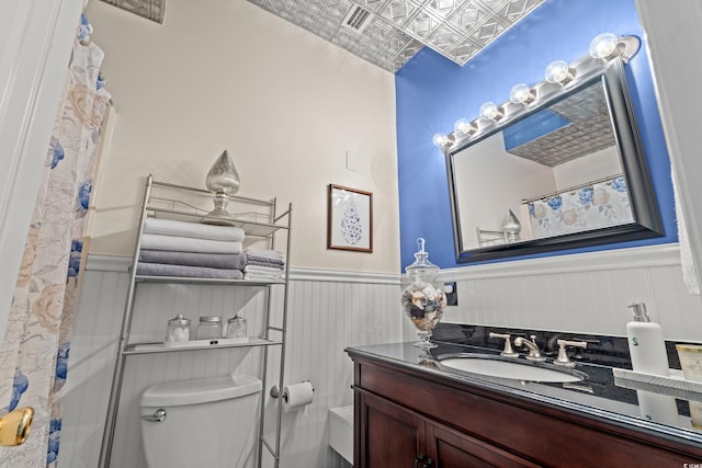 314 Lyons Cove Dr, Myrtle Beach, SC 29577 - bathroom featuring toilet, an ornate ceiling, wainscoting, vanity, and a shower with curtain