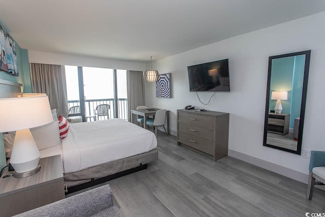 2401 S Ocean Blvd S Unit 1064, Myrtle Beach, SC 29577 - bedroom featuring wood finished floors, access to exterior, and baseboards