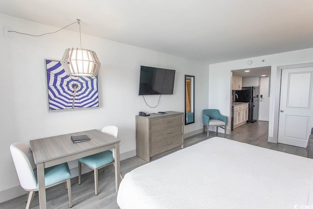 2401 S Ocean Blvd S Unit 1064, Myrtle Beach, SC 29577 - bedroom featuring wood finished floors, freestanding refrigerator, baseboards, and an office area