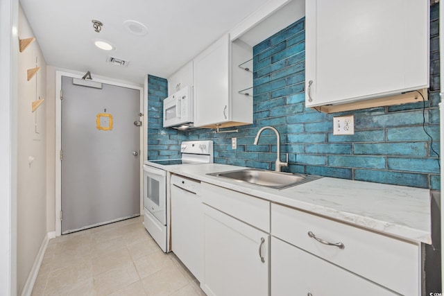 4000 N Ocean Blvd Unit 1002, North Myrtle Beach, SC 29582 - kitchen featuring white appliances, a sink, white cabinets, baseboards, and tasteful backsplash
