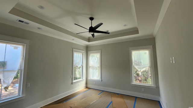 1424 Hydrangea Dr, Myrtle Beach, SC 29579 - empty room with a tray ceiling, plenty of natural light, ornamental molding, and a ceiling fan