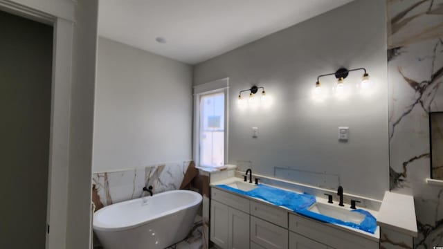 1424 Hydrangea Dr, Myrtle Beach, SC 29579 - bathroom featuring a soaking tub, double vanity, marble finish flooring, and tile walls