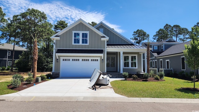 1424 Hydrangea Dr, Myrtle Beach, SC 29579 - view of front of house with driveway, board and batten siding, a front yard, a garage, and a standing seam roof