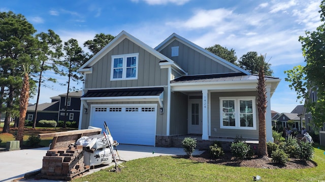 1424 Hydrangea Dr, Myrtle Beach, SC 29579 - view of front of property with board and batten siding, a porch, driveway, a garage, and metal roof