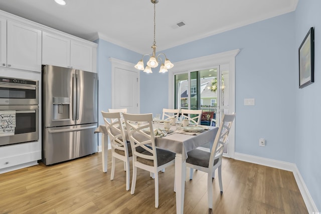 1012 Mary Read Dr, North Myrtle Beach, SC 29582 - dining space featuring a chandelier, light wood-type flooring, and baseboards
