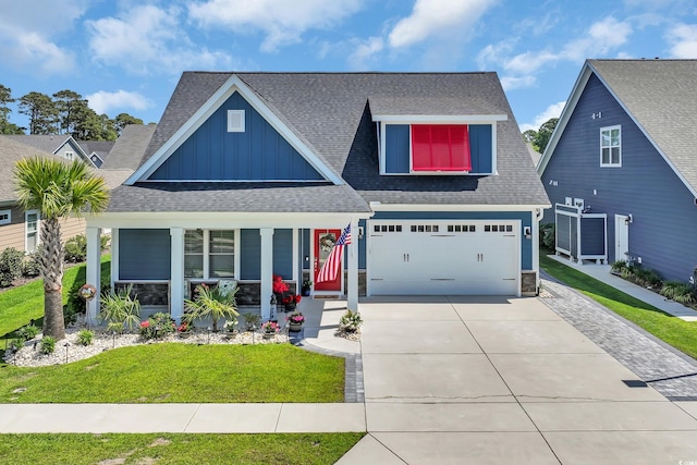 1012 Mary Read Dr, North Myrtle Beach, SC 29582 - view of front of property with board and batten siding, covered porch, concrete driveway, roof with shingles, and a front yard