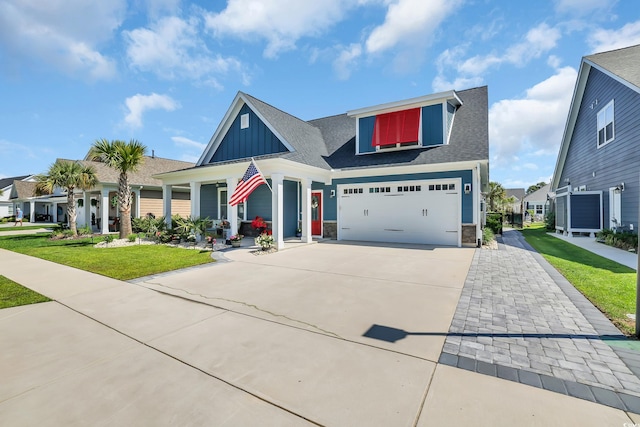 1012 Mary Read Dr, North Myrtle Beach, SC 29582 - view of front of property featuring driveway, board and batten siding, a front lawn, stone siding, and roof with shingles