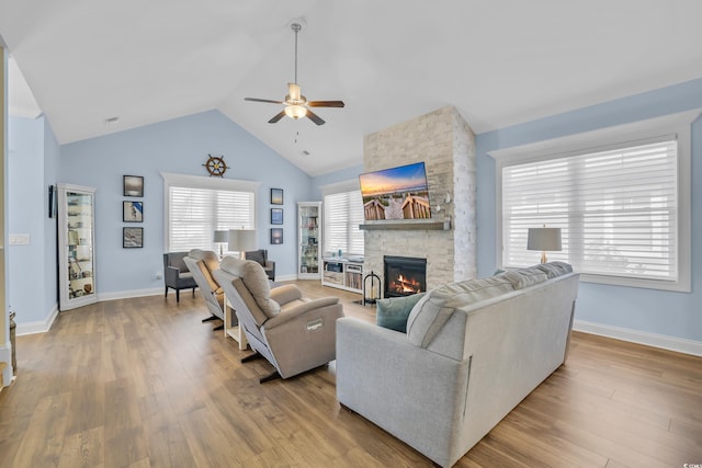 1012 Mary Read Dr, North Myrtle Beach, SC 29582 - living area featuring ceiling fan, a stone fireplace, wood finished floors, baseboards, and high vaulted ceiling