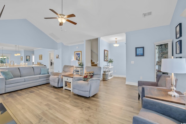 1012 Mary Read Dr, North Myrtle Beach, SC 29582 - living area with stairway, light wood finished floors, ceiling fan, high vaulted ceiling, and baseboards