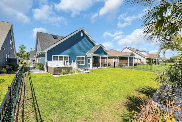 1012 Mary Read Dr, North Myrtle Beach, SC 29582 - back of property featuring a fenced backyard, a hot tub, and a shingled roof