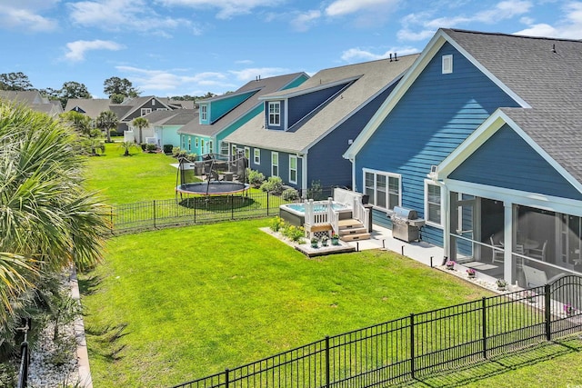 1012 Mary Read Dr, North Myrtle Beach, SC 29582 - rear view of house featuring a trampoline, a fenced backyard, a shingled roof, a residential view, and a sunroom
