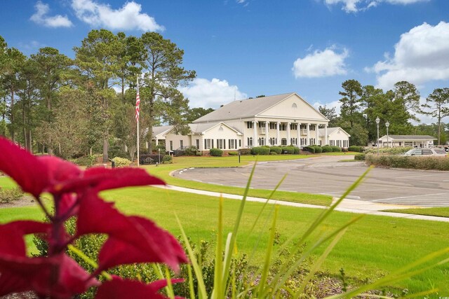 8715 Baton Rouge Ave NW, Calabash, NC 28467 - view of home's community with a lawn and uncovered parking