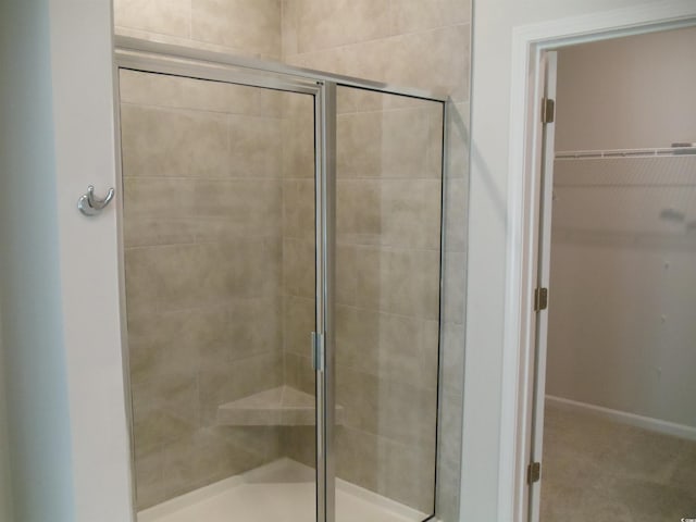 8715 Baton Rouge Ave NW, Calabash, NC 28467 - bathroom featuring a stall shower and a spacious closet
