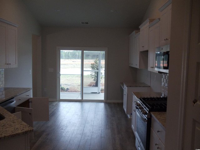 8715 Baton Rouge Ave NW, Calabash, NC 28467 - kitchen with appliances with stainless steel finishes, baseboards, backsplash, white cabinetry, and dark wood-type flooring