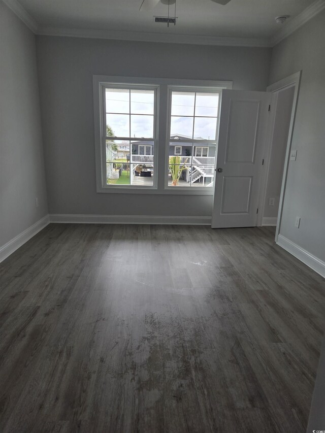4823 Riverside Dr, North Myrtle Beach, SC 29582 - spare room with ornamental molding, baseboards, and dark wood-style flooring