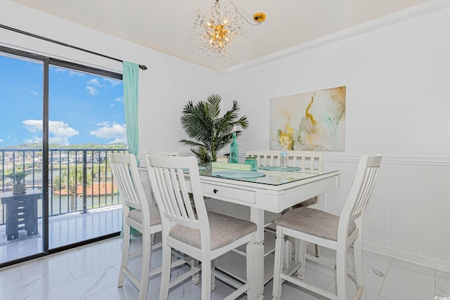5905 S Kings Hwy Unit 344B, Myrtle Beach, SC 29575 - dining space with marble look tile flooring, a chandelier, and a wainscoted wall