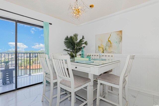5905 S Kings Hwy Unit 344B, Myrtle Beach, SC 29575 - dining room featuring a chandelier, marble finish flooring, and a wainscoted wall