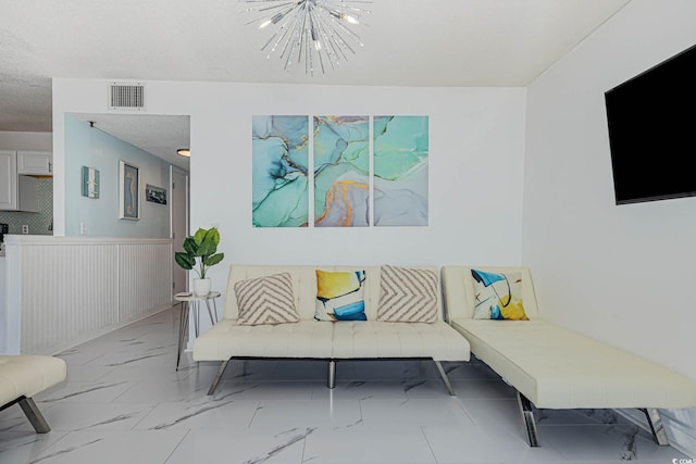 5905 S Kings Hwy Unit 344B, Myrtle Beach, SC 29575 - living room with wainscoting, a chandelier, and marble look tiles
