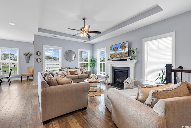 104 Splendor Cir, Murrells Inlet, SC 29576 - living area featuring a raised ceiling, a ceiling fan, wood-type flooring, and baseboards