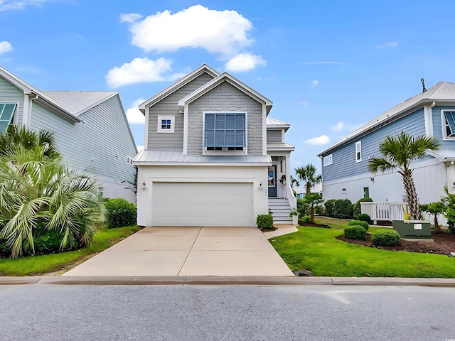 104 Splendor Cir, Murrells Inlet, SC 29576 - view of front of house featuring a garage, concrete driveway, a front lawn, a standing seam roof, and metal roof