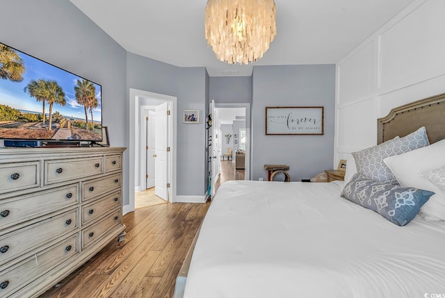 104 Splendor Cir, Murrells Inlet, SC 29576 - bedroom with wood finished floors, a chandelier, ensuite bathroom, and baseboards