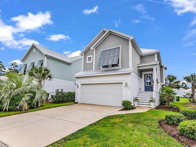 104 Splendor Cir, Murrells Inlet, SC 29576 - view of front of property with an attached garage, metal roof, concrete driveway, board and batten siding, and a front lawn