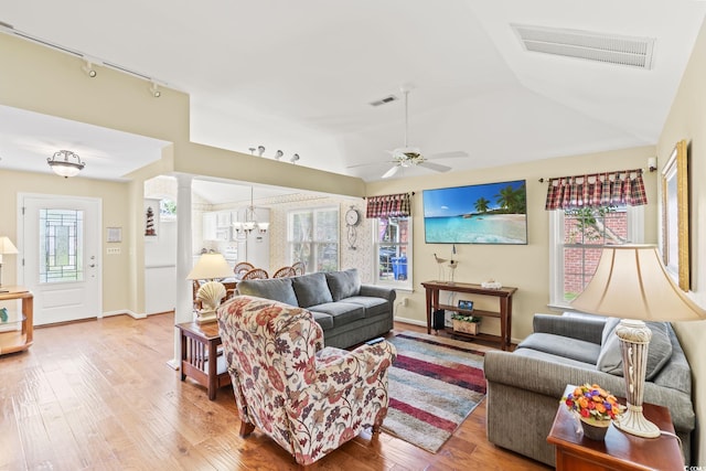 4002 Acorn Way N, Myrtle Beach, SC 29582 - living room featuring wood-type flooring, rail lighting, ornate columns, a chandelier, and a ceiling fan