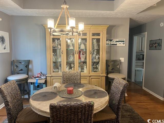 550 Bridgeport Dr, Myrtle Beach, SC 29577 - dining room with a chandelier, wood finished floors, and baseboards