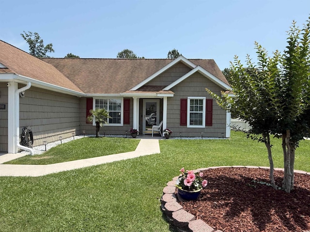 550 Bridgeport Dr, Myrtle Beach, SC 29577 - view of front facade featuring a shingled roof and a front lawn