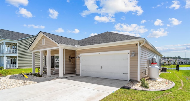 1664 White Starfish Ct, Calabash, NC 28467 - view of front of home featuring an attached garage, a front lawn, concrete driveway, roof with shingles, and a porch
