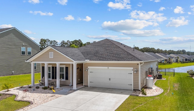 1664 White Starfish Ct, Calabash, NC 28467 - view of front of home with a porch, an attached garage, driveway, and a shingled roof