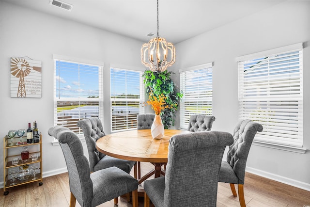 1664 White Starfish Ct, Calabash, NC 28467 - dining space featuring a chandelier, light wood-style flooring, and baseboards