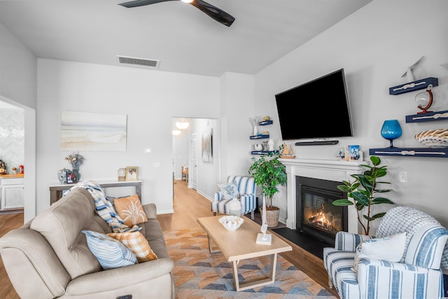1664 White Starfish Ct, Calabash, NC 28467 - living area with wood finished floors, a glass covered fireplace, and a ceiling fan