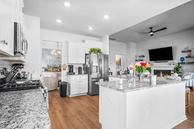 1664 White Starfish Ct, Calabash, NC 28467 - kitchen with stainless steel appliances, open floor plan, a ceiling fan, light wood-style flooring, and white cabinets