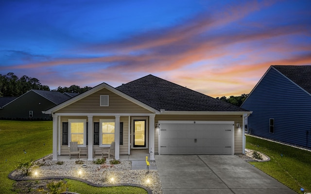 1664 White Starfish Ct, Calabash, NC 28467 - traditional-style home featuring a garage, covered porch, a yard, concrete driveway, and roof with shingles