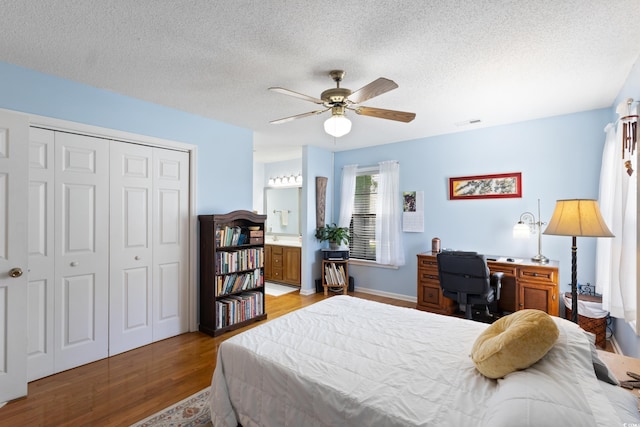 1422 Baldwin Ct Unit 1422, Little River, SC 29566 - bedroom featuring light wood-style floors, a closet, ceiling fan, a textured ceiling, and ensuite bath